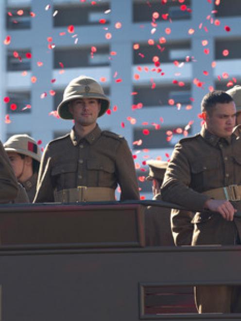Soldiers in a cloud of poppies during the Anzac Street Parade in Wellington. Photo NZ Herald.
