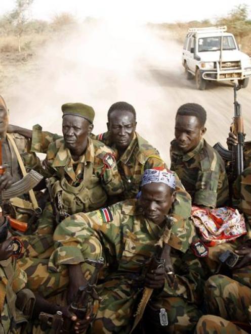 Soldiers of South Sudan's army, or the SPLA, ride in a truck on the frontline with Sudan last...