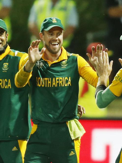 South Africa's AB De Villiers (2nd R) celebrates with team mate Dale Steyn after dismissing...