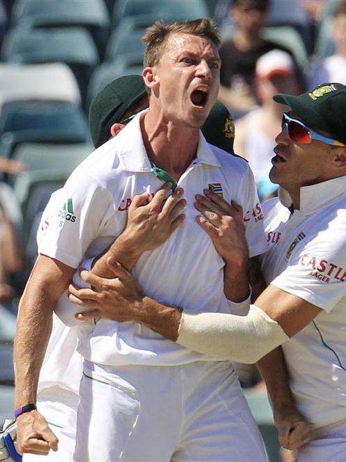 South Africa's Dale Steyn is congratulated by team mates after dismissing Australia's Mike Hussey...