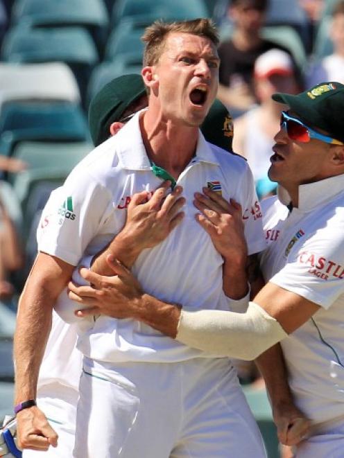 South Africa's Dale Steyn (L) is congratulated by team mates after dismissing Australia's Mike...