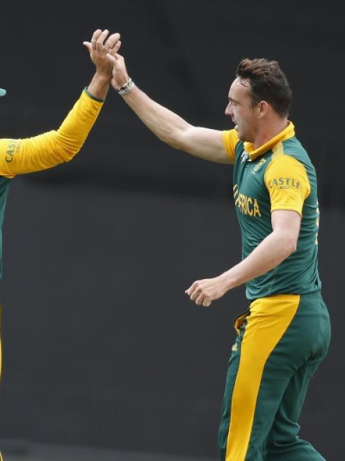 South Africa's Kyle Abbott celebrates with teammate Rilee Rossouw after dismissing Pakistan's...