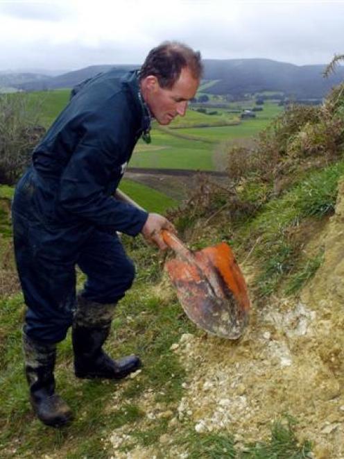 South Otago dairy farmer Tony McDonnel checks a phosphate outcrop on his farm. Photo by Gerard O...
