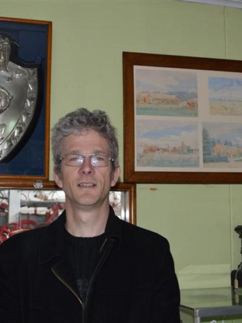 South Otago Museum curator Gary Ross with the Lawes Challenge shield and  six restored paintings...