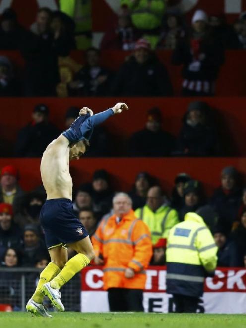 Southampton's Dusan Tadic removes his shirt as he celebrates his goal during their English...