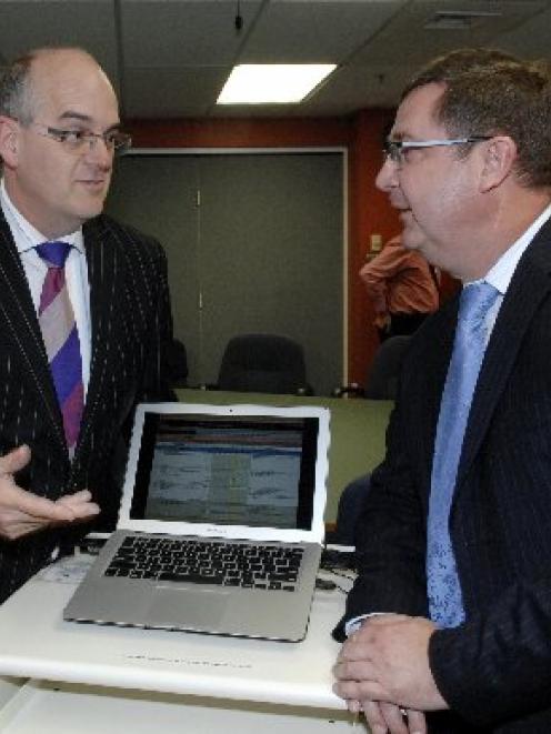 Southern DHB medical director of IT Dr Andrew Bowers (right) shows Health Minister Tony Ryall a...