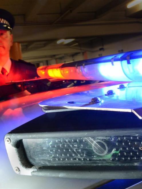 Southern District acting road policing manager Senior Sergeant Steve Larking with a patrol car...