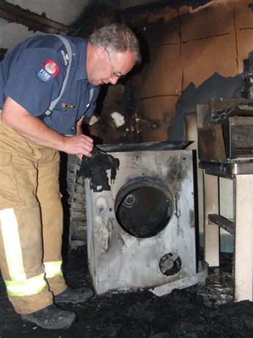 Southern Fire Region fire safety officer Barry Gibson investigates the upstairs storage room at...