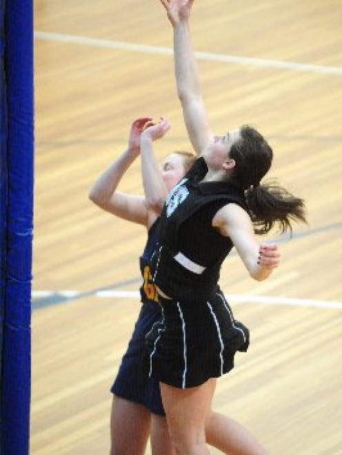 Southern's Kate Shearer shoots past Phys Ed's Hannah Coutts in their Dunedin premier netball game...