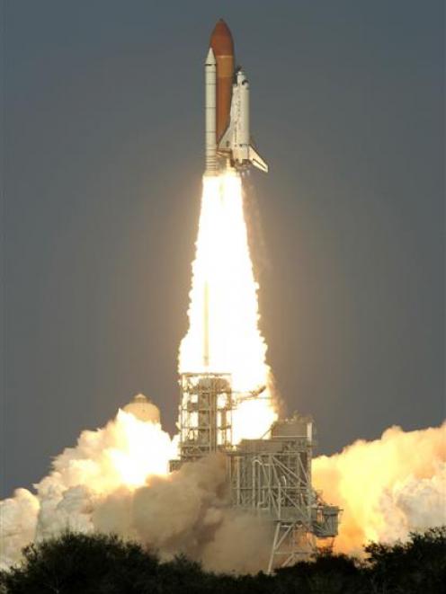Space shuttle Discovery lifts off from the Kennedy Space Centre in Cape Canaveral, Florida on its...