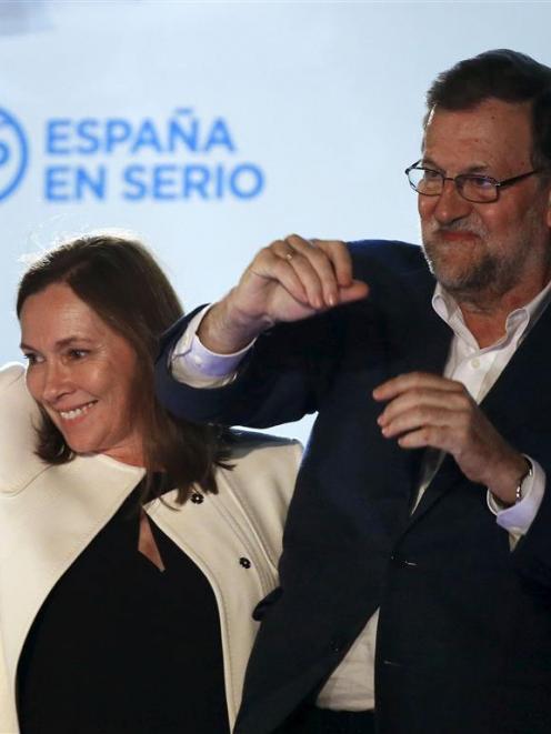 Spain’s Prime Minister and People’s Party  candidate Mariano Rajoy gestures while addressing...