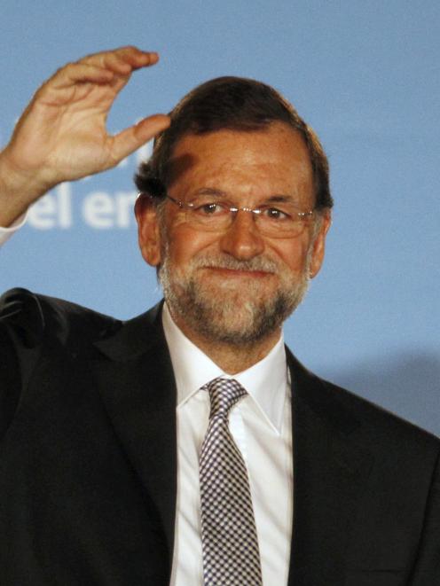 Spain's centre-right People's Party (Partido Popular) leader Mariano Rajoy acknowledges...