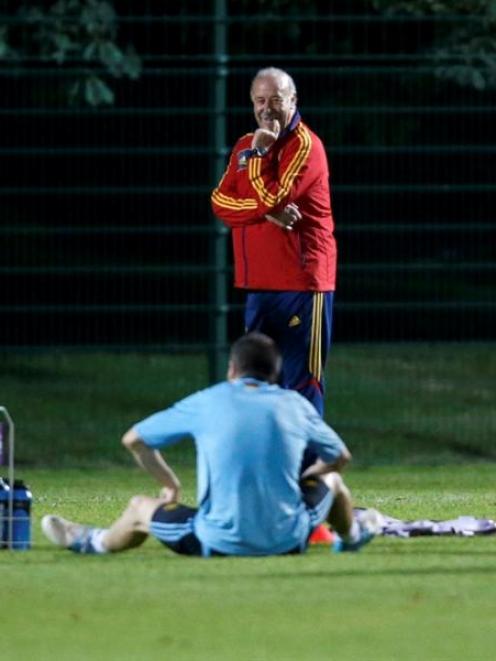 Spain's national soccer coach Vicente del Bosque looks at Andres Iniesta on the pitch during a...