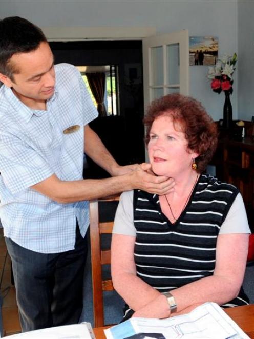 Speech language therapist Warren Cossou checks Margaret Fisher's swallow in her Dunedin home....