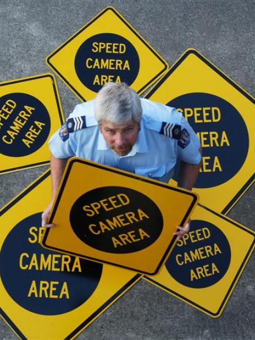 Sergeant Tony Bridgman, of Dunedin, with redundant speed camera signs taken down around the city...