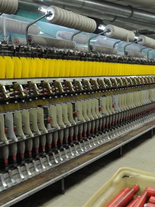 Spinner Haley Scott watches her woollen spinning frame take carded wool and possum fur from...