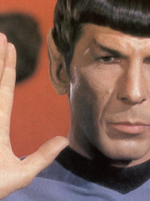Spock, played by Leonard Nimoy, does the iconic Vulcan salute.