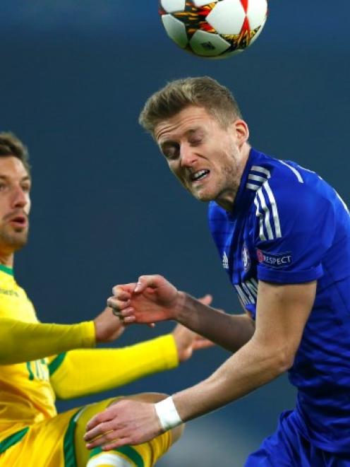 Sporting's Adrien Silva (L) challenges Chelsea's Andre Schurrle during their Champions League...