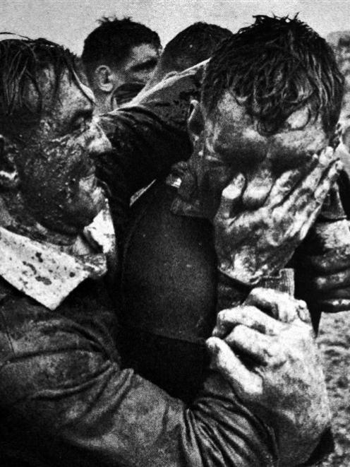 Springbok centre John Gainsford smears mud into the face of Colin Meads during the first test at...