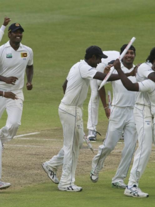 Sri Lanka players celebrate winning the second cricket test against South Africa in Durban....