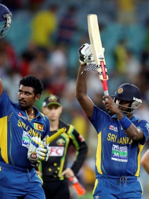 Sri Lanka's Angelo Mathews and Thisara Perera (L) acknowledge their supporters in the crowd after...