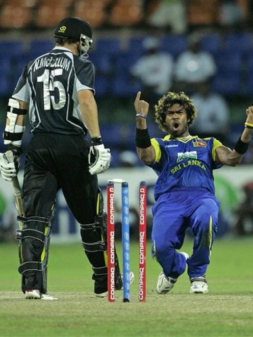 Sri Lanka's Lasith Malinga, right, celebrates the dismissal of New Zealand's Brendon McCullum in...