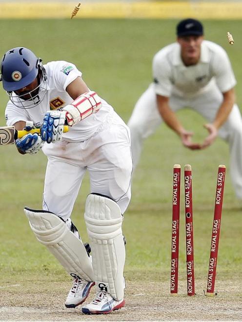 Sri Lanka's Tillakaratne Dilshan is bowled by New Zealand's Tim Southee. REUTERS/Dinuka Liyanawatte
