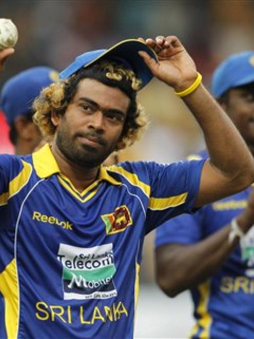Sri Lankan bowler Lasith Malinga acknowledges the crowd after completing a hat-trick during the...