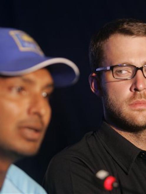 Sri Lankan cricket captain Kumar Sangakkara, left, speaks as New Zealand captain Daniel Vettori...