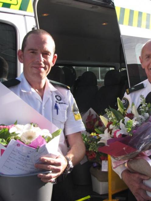 St John  staff Ian Harvey (left) and Russell Glendinning, with some of the bouquets of flowers...
