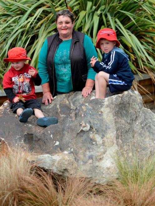 St Kilda Kindergarten teacher June Aerakis with brothers Jae (3, left) and Nate (4) Roome on the...