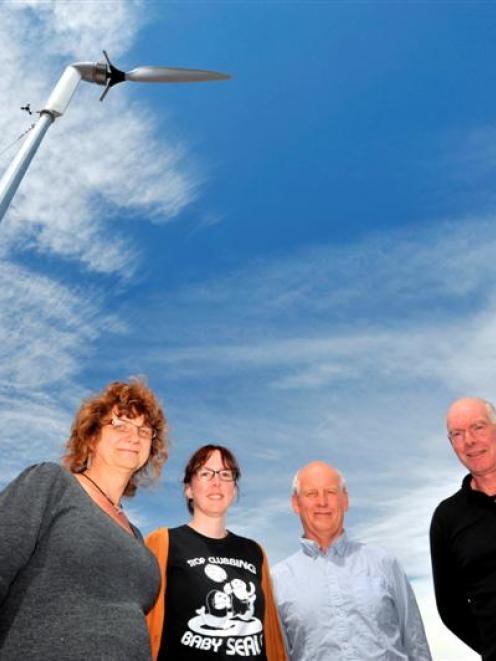 Standing below a wind turbine installed on the roof of Otago Polytechnic's D block are (from left...