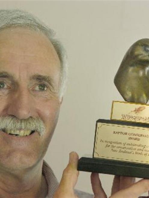 Steve Lawrence, of Outram, with the conservation award he received for his work with falcons....