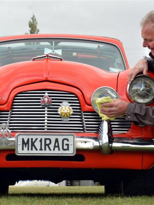 Steve Roy, of Dunedin, cleans his 1954 Mark 1 Zephyr convertible after his run to the Strath...