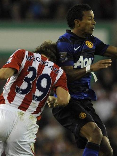 Stoke City's Jonathan Woodgate challenges Manchester United's Nani. REUTERS/Nigel Roddis