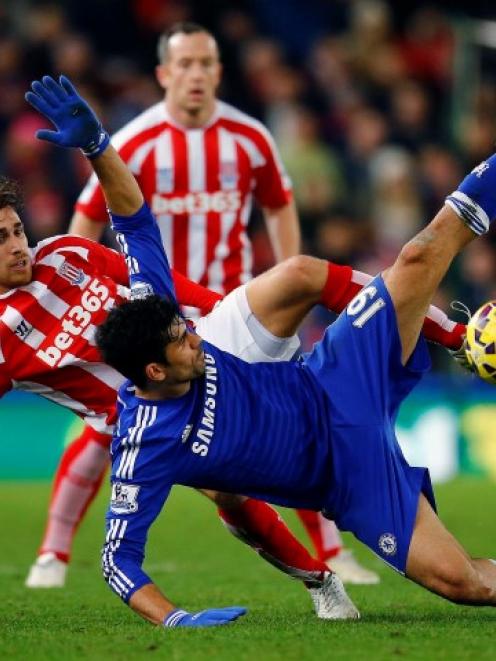 Stoke City's Marc Muniesa (L) challenges Chelsea's Diego Costa. REUTERS/Darren Staples