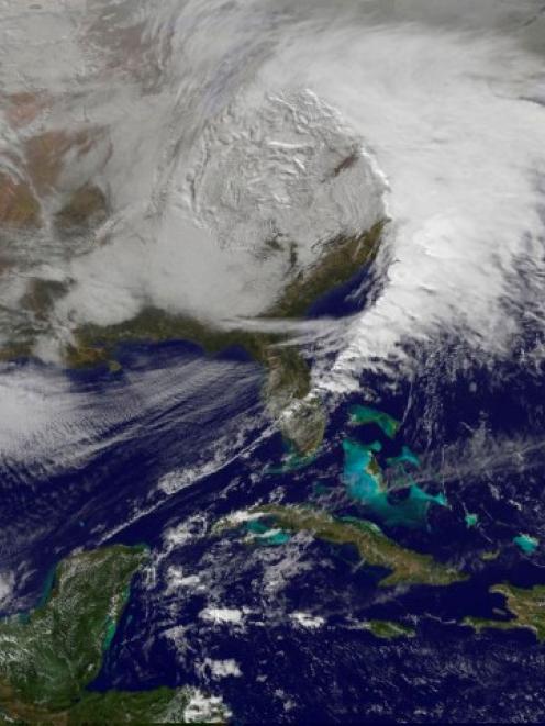 Storm clouds are seen on the east coast of the United States in this NASA handout satellite image...