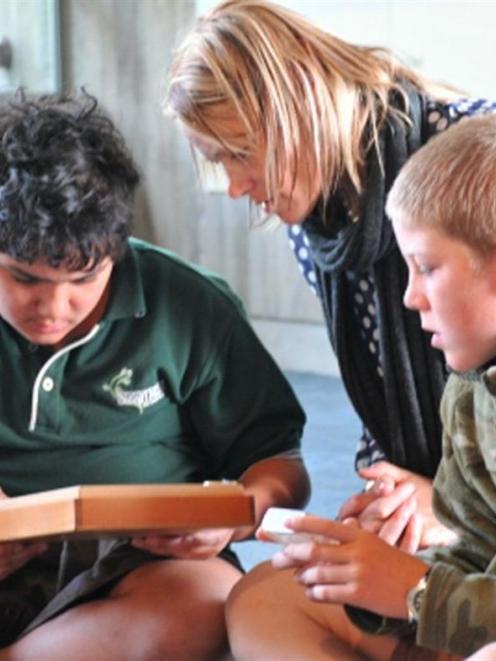 Strath Taieri School principal Vicki McIntyre (centre) works with pupils (from left) Charles...