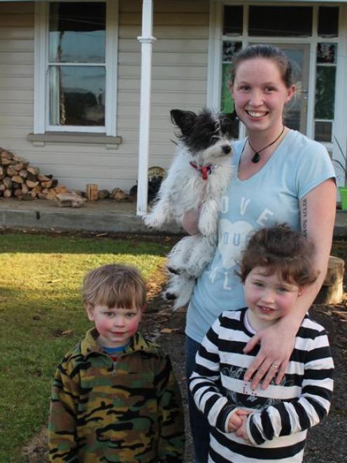 Stroke survivor Emma Petch with her children Rylie (2) and Skye (4), and Maisy the dog, outside...