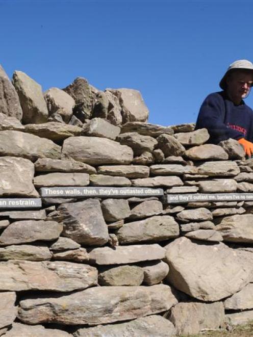 Stuart Griffiths builds a drystone wall with Brian Turner poetry inset at the West Taieri cemetery.