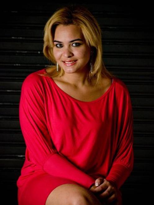 Student Geisy Arruda poses at her home in Sao Paulo wearing the same dress that she was expelled...