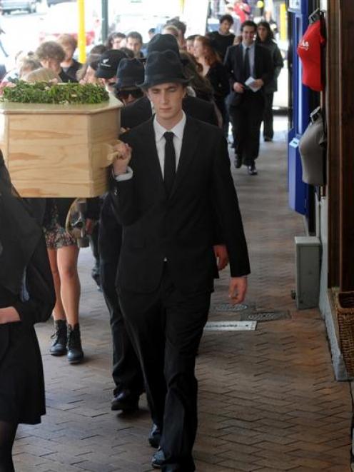 Students and environmentalists carry a coffin through Dunedin to raise awareness of environmental...