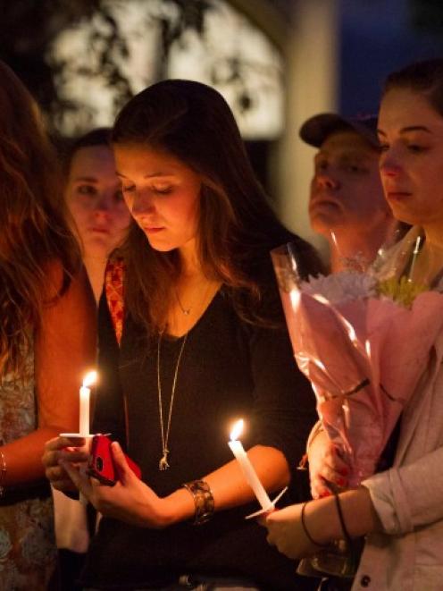 Students and staff members attend a candle light vigil on Boston University Campus in Boston,...