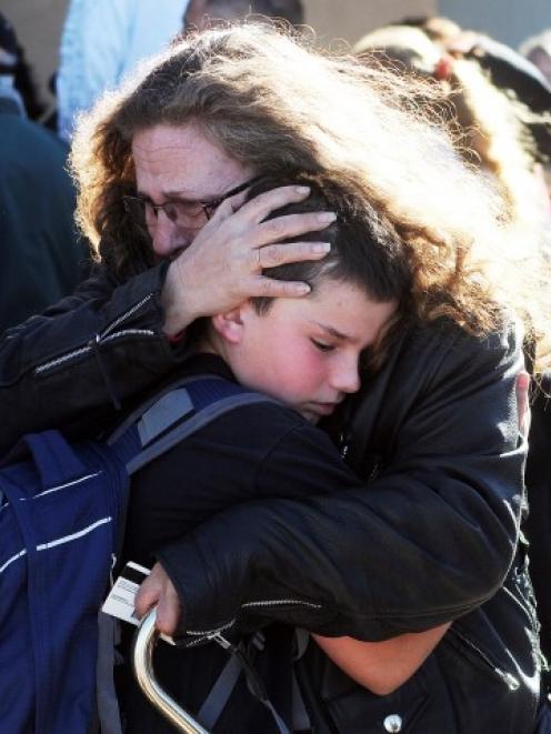 Students are reunited with families at a staging ground set up at the Roswell Mall following the...