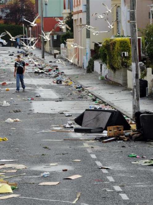 Students survey the mess after Saturday's Hyde St keg party. Photo by Stephen Jaquiery.