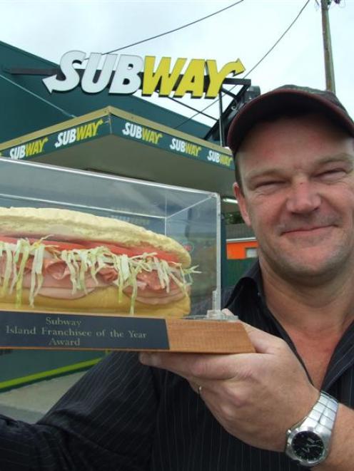 Subway Balclutha co-owner Richard Jackson admires the sandwich trophy that confirms the South...