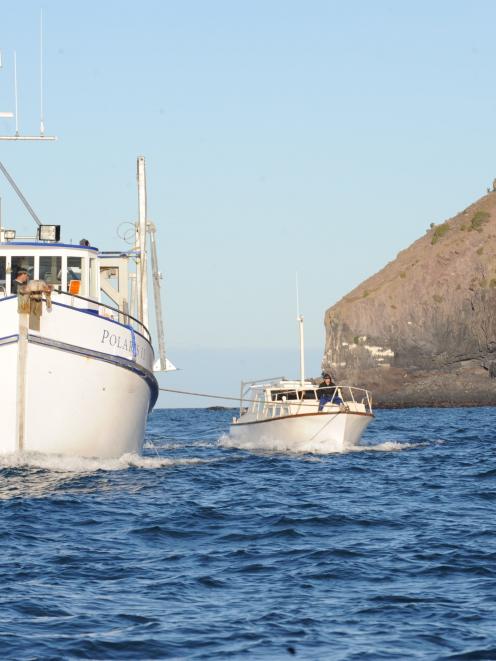 University of Otago research vessel Polaris II tows Summer Wine back to Port Chalmers past...
