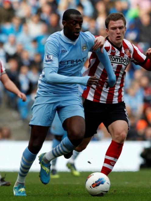 Sunderland's Craig Gardner (R) challenges Manchester City's Yaya Toure during their English...
