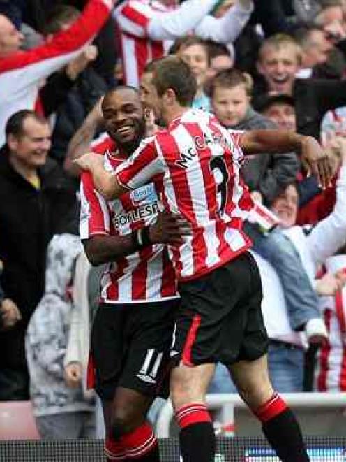 Sunderland's Darren Bent, left, celebrates his goal with teammate George McCartney during their...