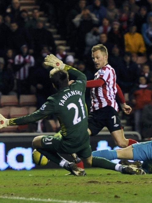 Sunderland's Sebastien Larsson (C) shoots to score against Arsenal during their FA Cup match in...